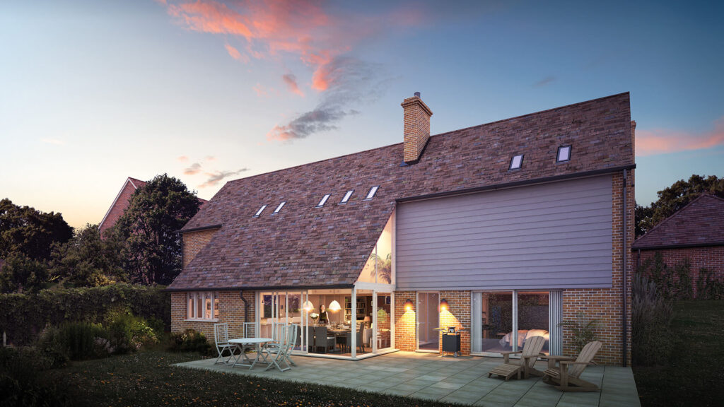 A CGI render of the rear angle of plot 3 of our Apple Tree Gardens development. An evening shot of the back of the house, ceramic tiles make up a patio, and the back of the dining are has large glass doors that are open to the garden.